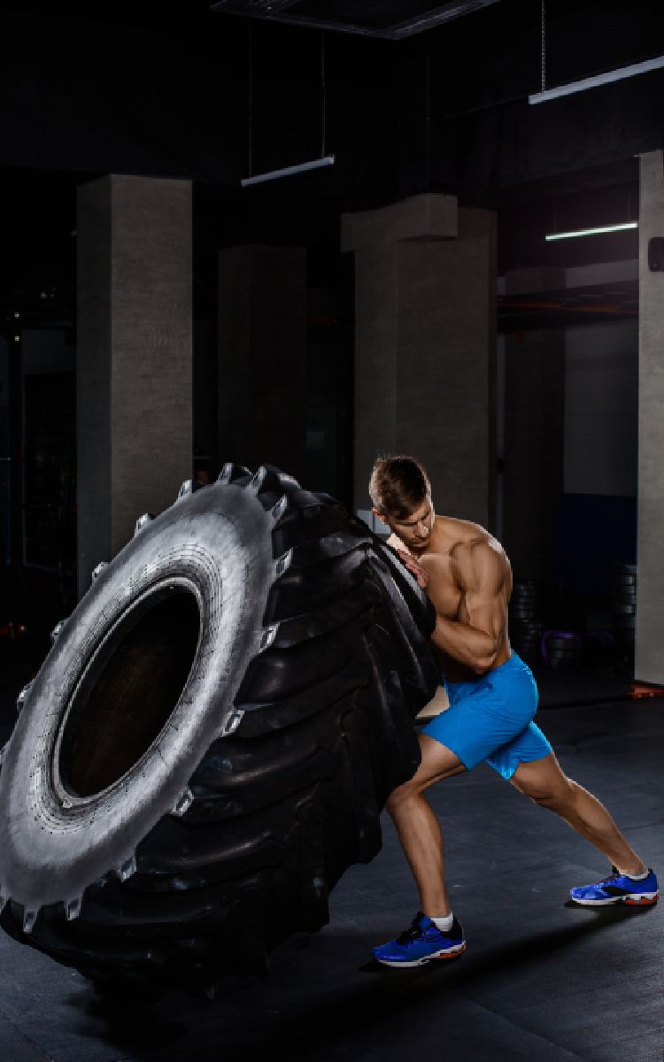 man-pushes-big-tire